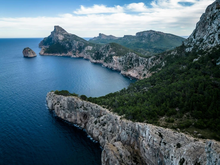 an aerial view of two rock formations near the water