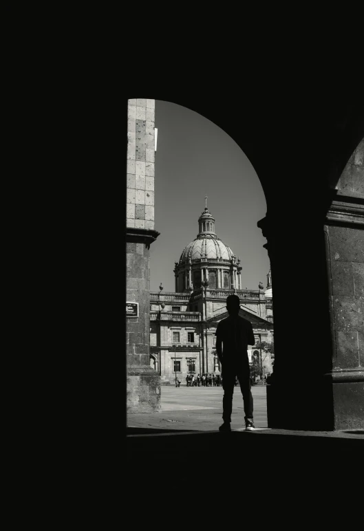 the man is standing in front of the building