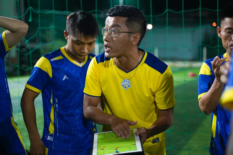 several men look on at a soccer game