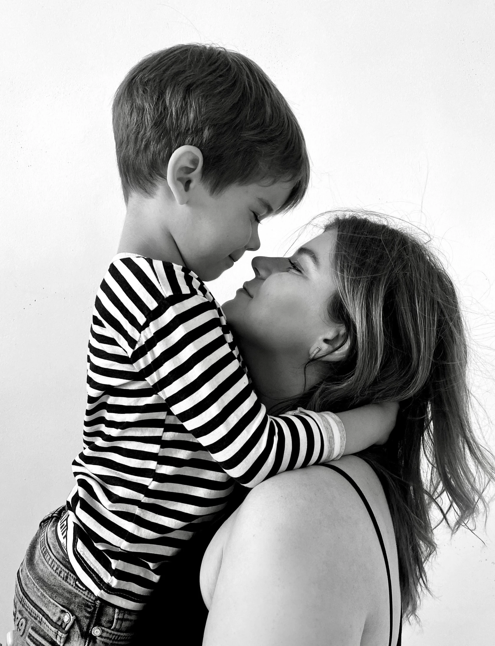 a black and white image of two people hugging