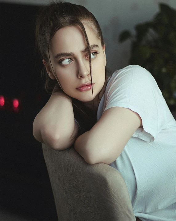 a young lady sitting on top of a chair posing for a po