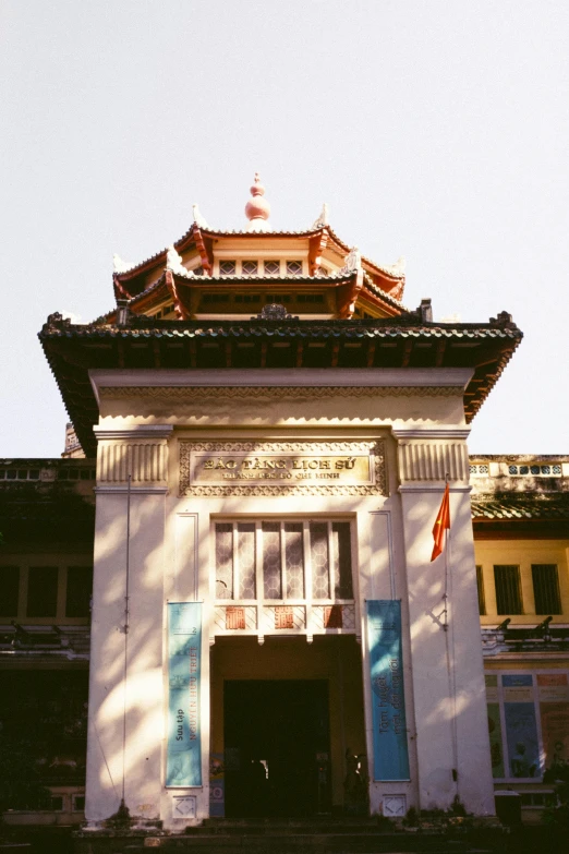 a tall white building with blue shutters on the side