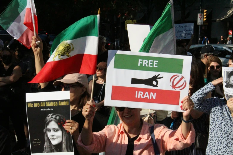 a group of people holding up signs and flags