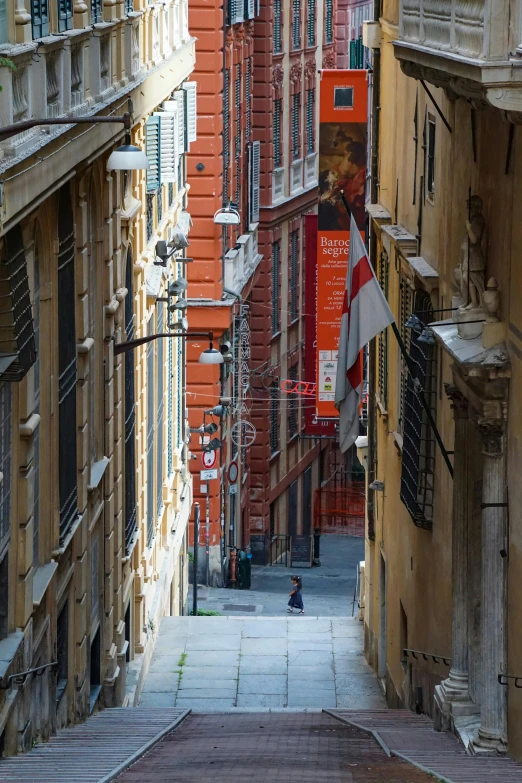 some orange building white and black sign a brown brick walkway and a person