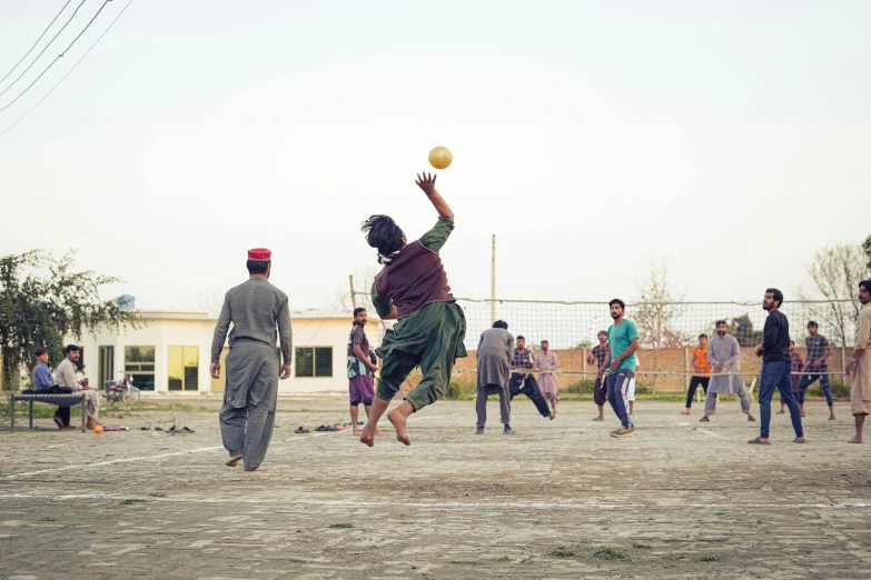 some people playing frisbee in the dirt