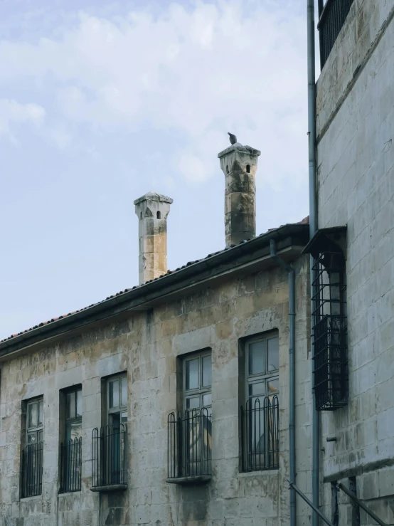 two buildings are side by side and one has a clock