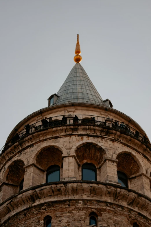 the top of an old stone building with circular windows