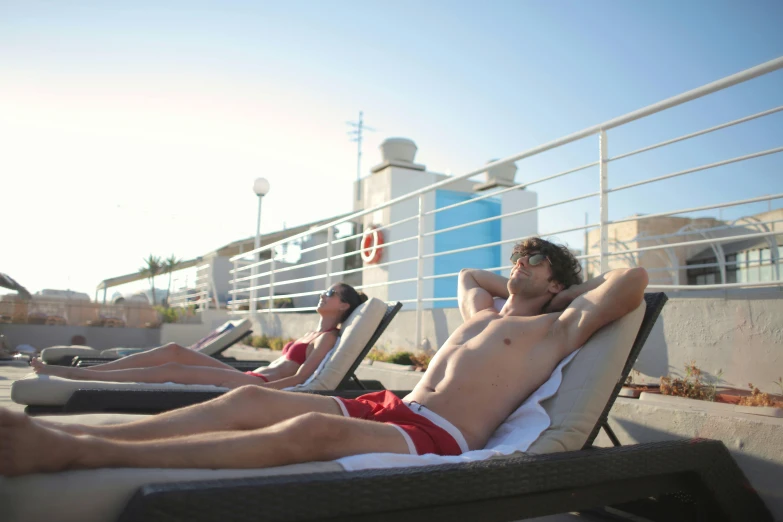 a couple of people are lying on the beach