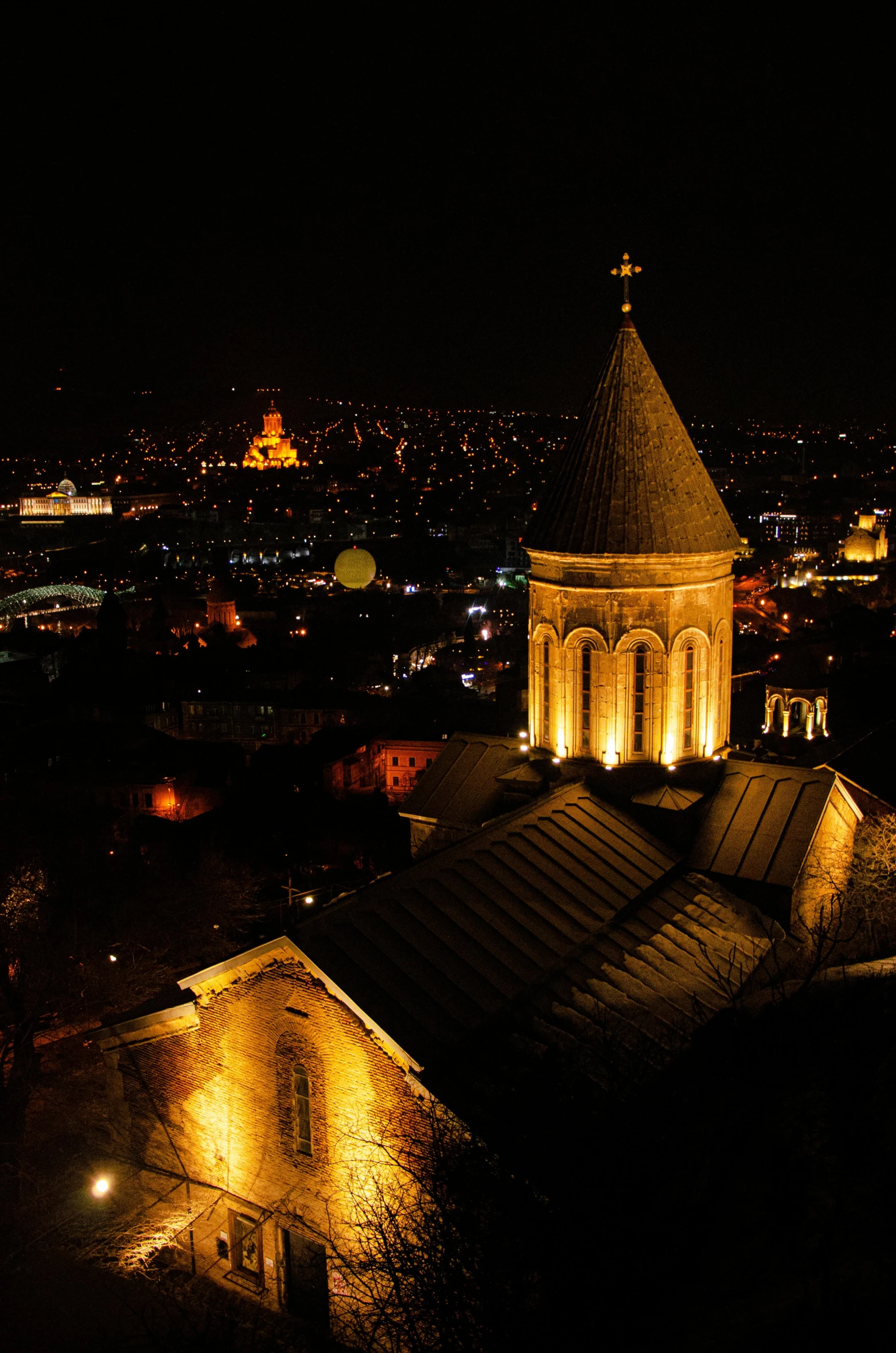 a view of some tall buildings with lights