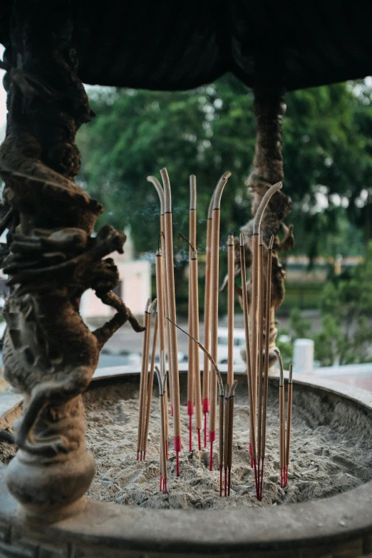 a bowl that has candles and sticks in it