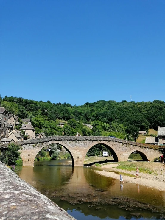 the stone bridge has arched arches and many stone buildings