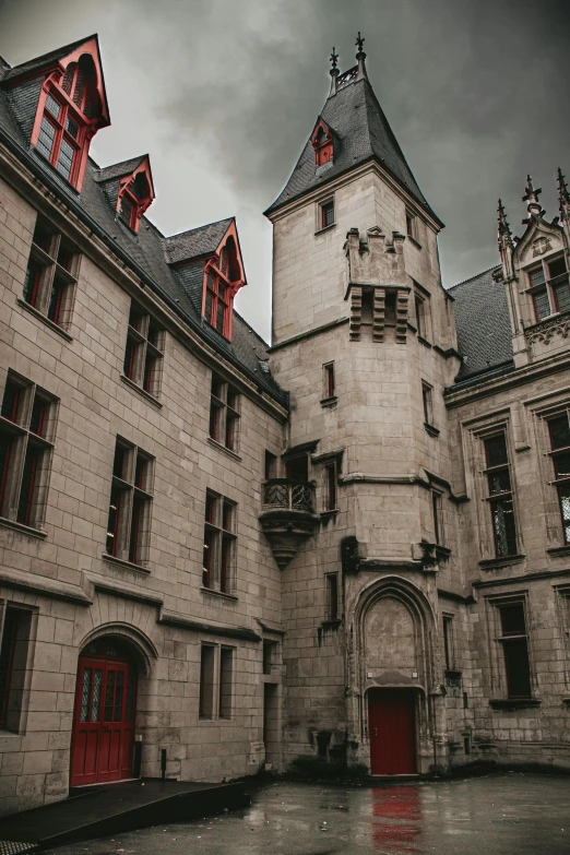 an old castle with two towers and red doors