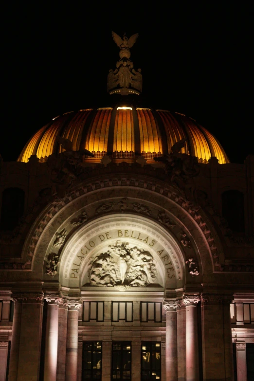 an illuminated building with arches and columns