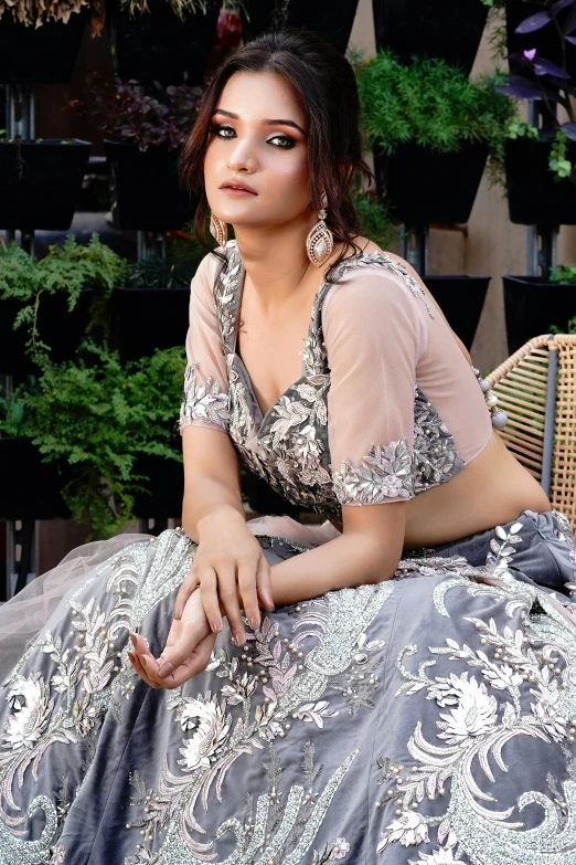 an indian woman sitting on the ground and posing