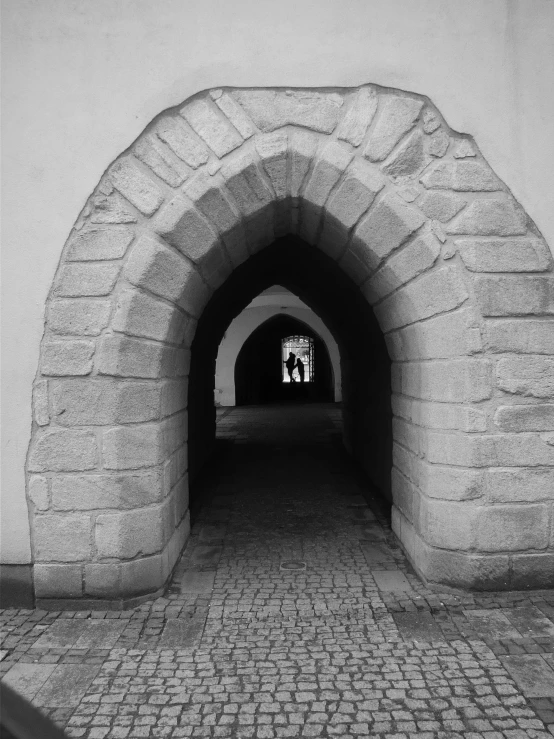 a tunnel with one lane and brick walls