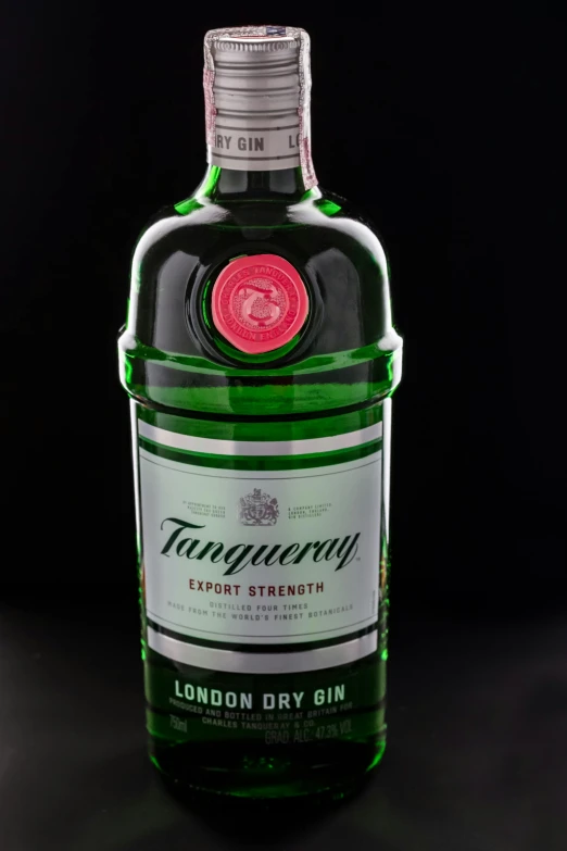 a green and white bottle of wine with black background