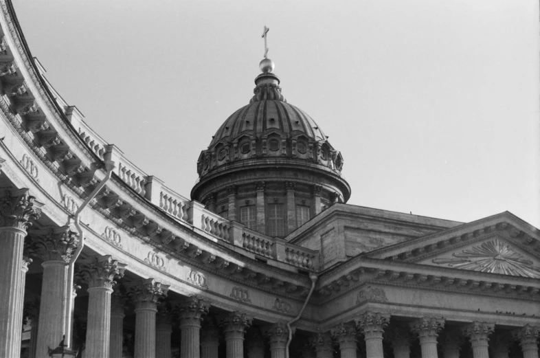 a building with pillars and a dome near it