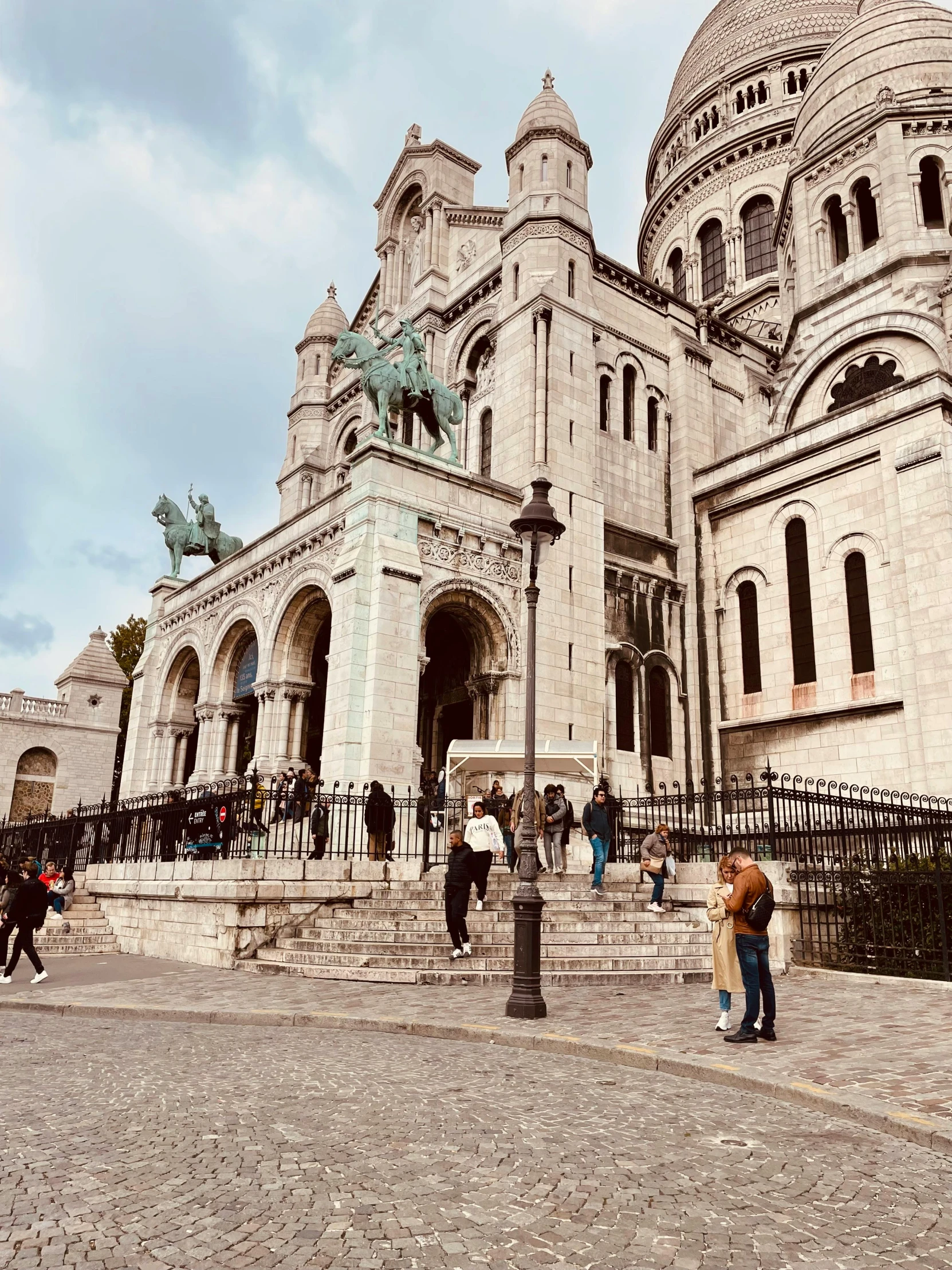 a large building that has a steeple and dome on it