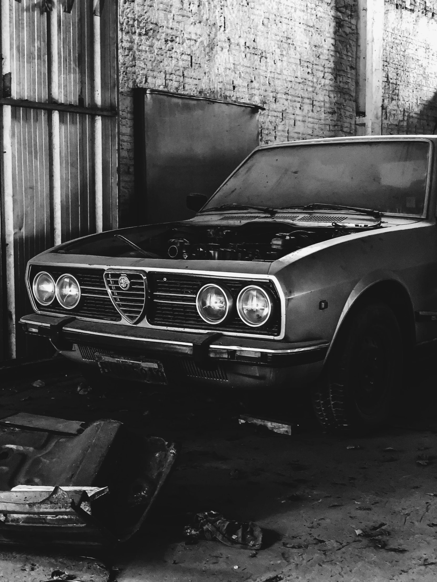 a vintage car sitting in a dark garage