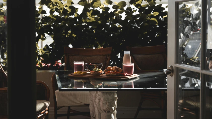 a glass table that has food and drinks on it