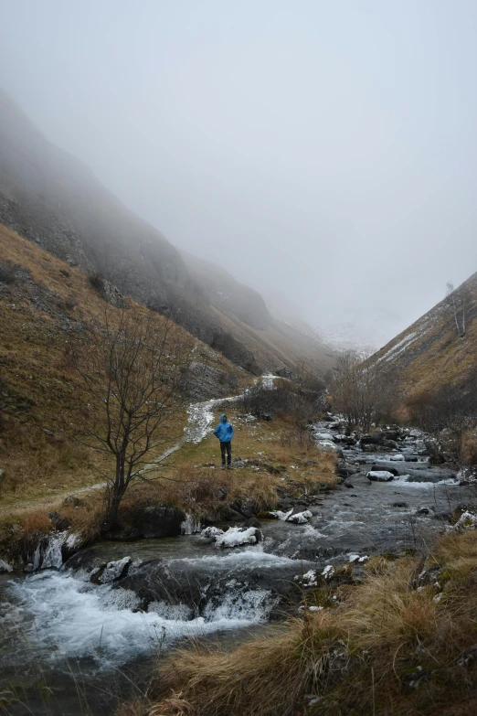 a person standing on top of a river