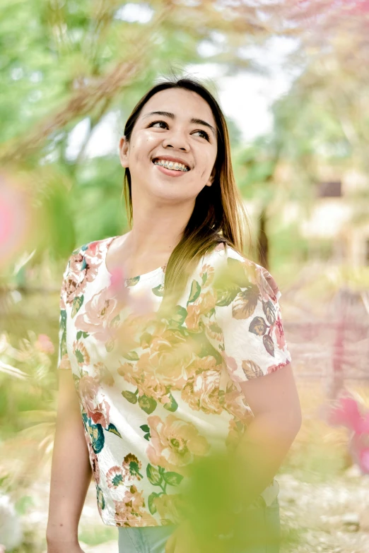 an asian woman standing with her eyes closed