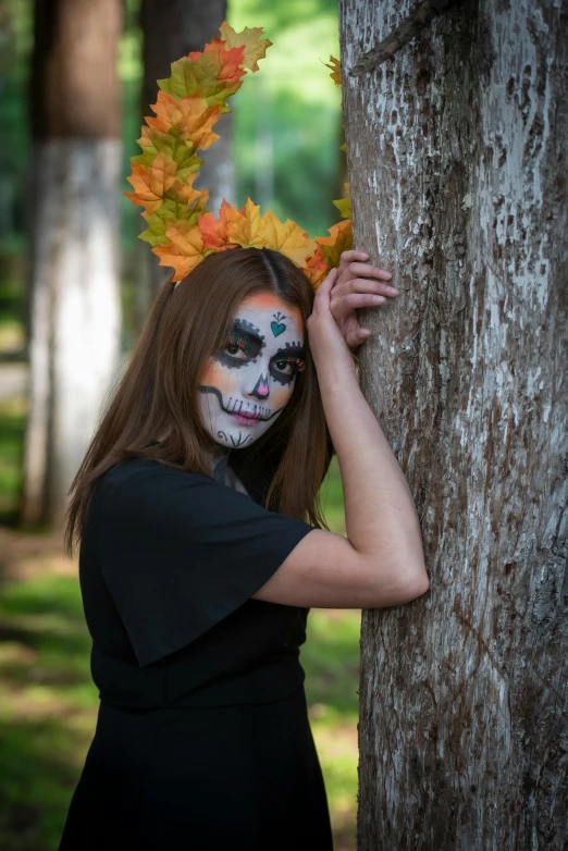 a woman with makeup painted to look like a skeleton