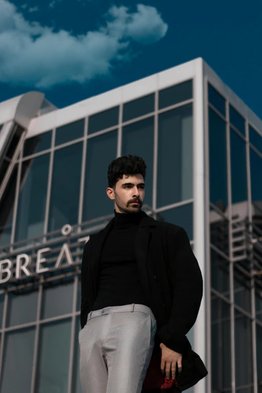 a man that is standing up near a building