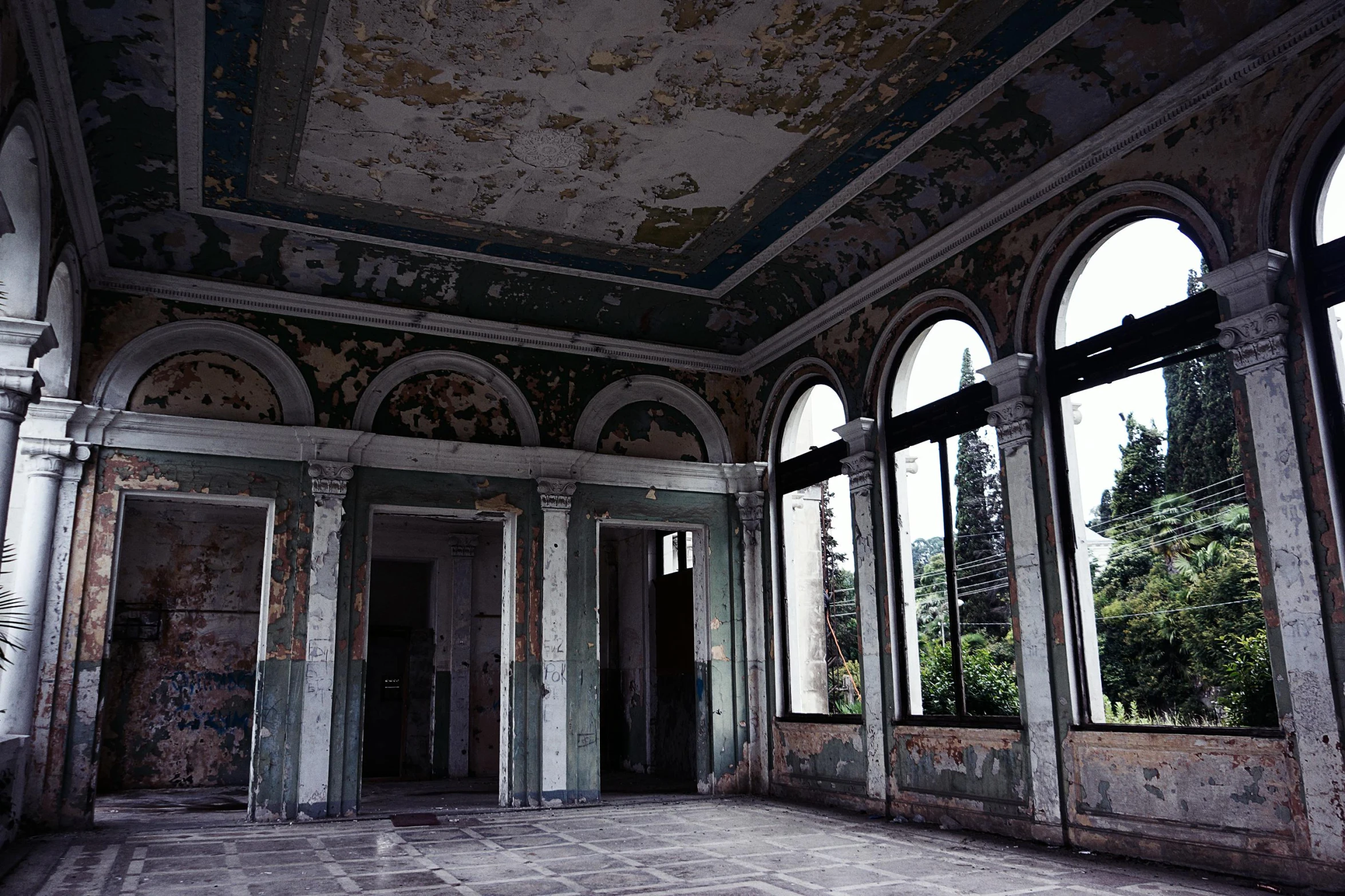 the interior of an old building with a clock on the ceiling