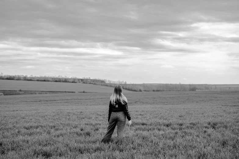 a person standing in a field with a kite