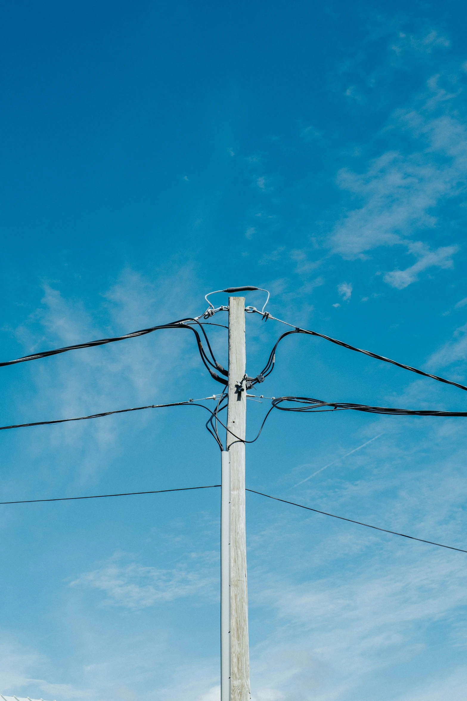 a telephone pole is covered with wire and electrical lines