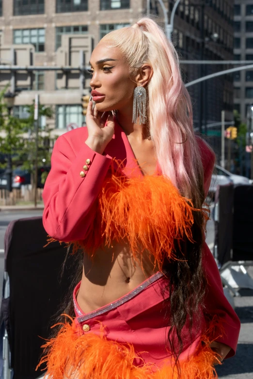 a woman is walking in the street wearing bright clothing