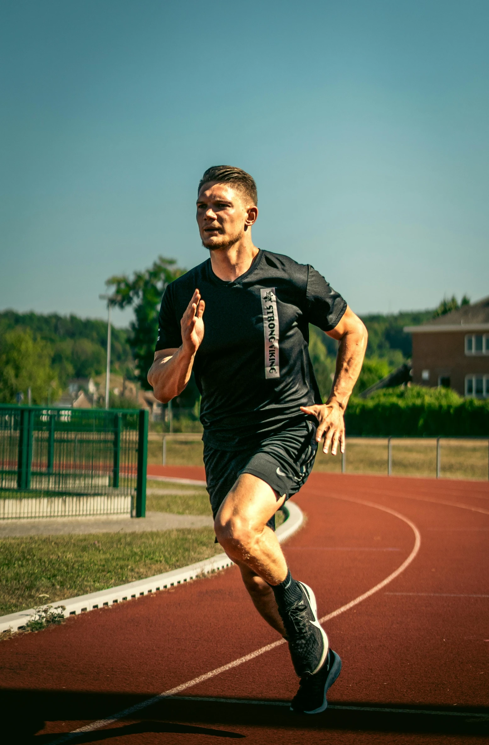 man on a running track runs forward