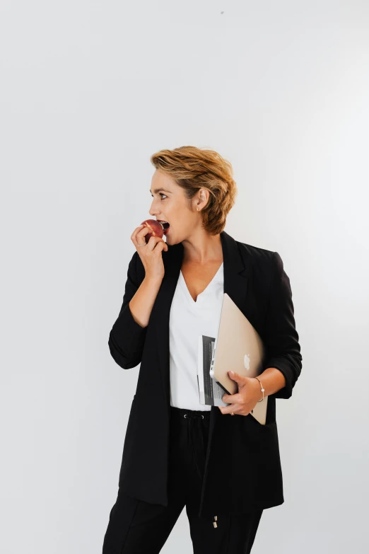 a woman talking on a cellphone with a notebook in her hand