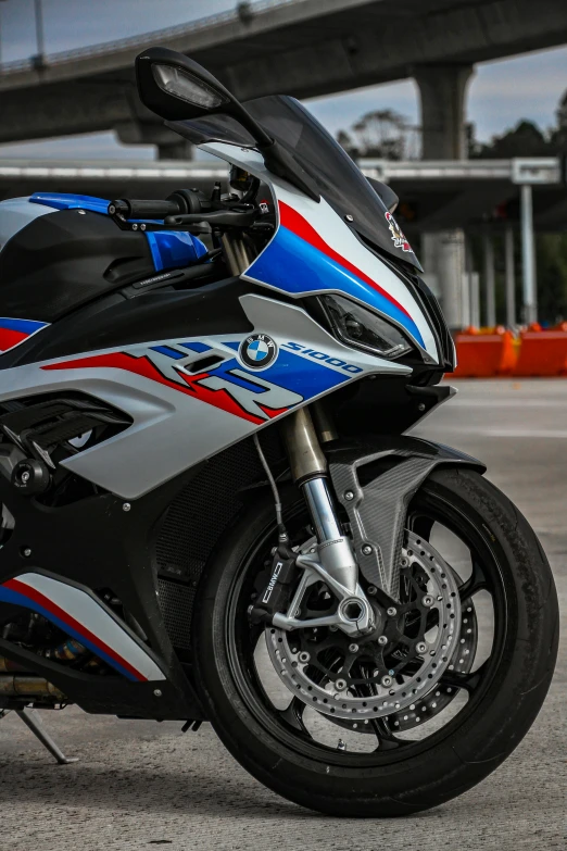 a motorcycle parked in a parking lot with a blue and white stripe on it