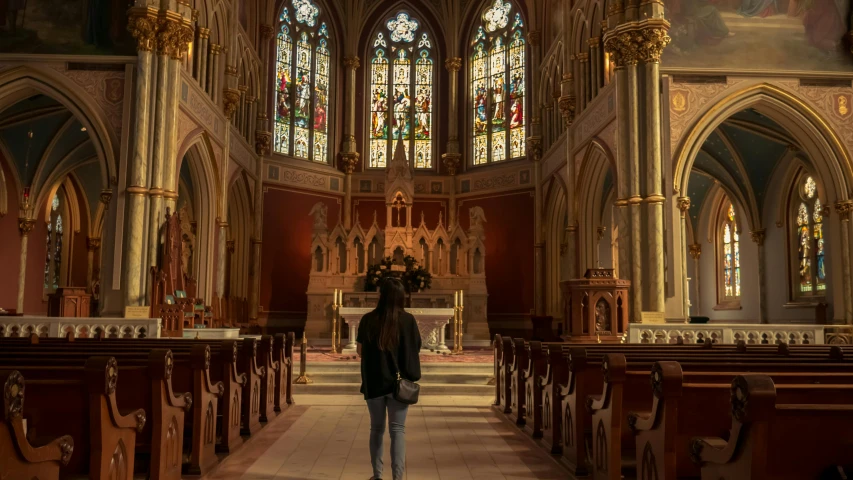 a man standing in the aisle of an old church