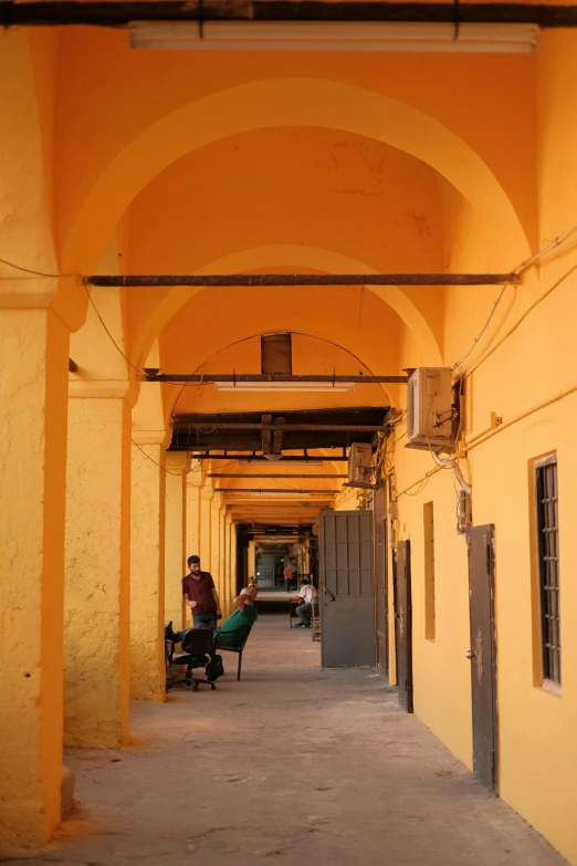 a man sitting on a bench under an archway