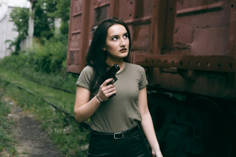 there is a woman standing in front of a train