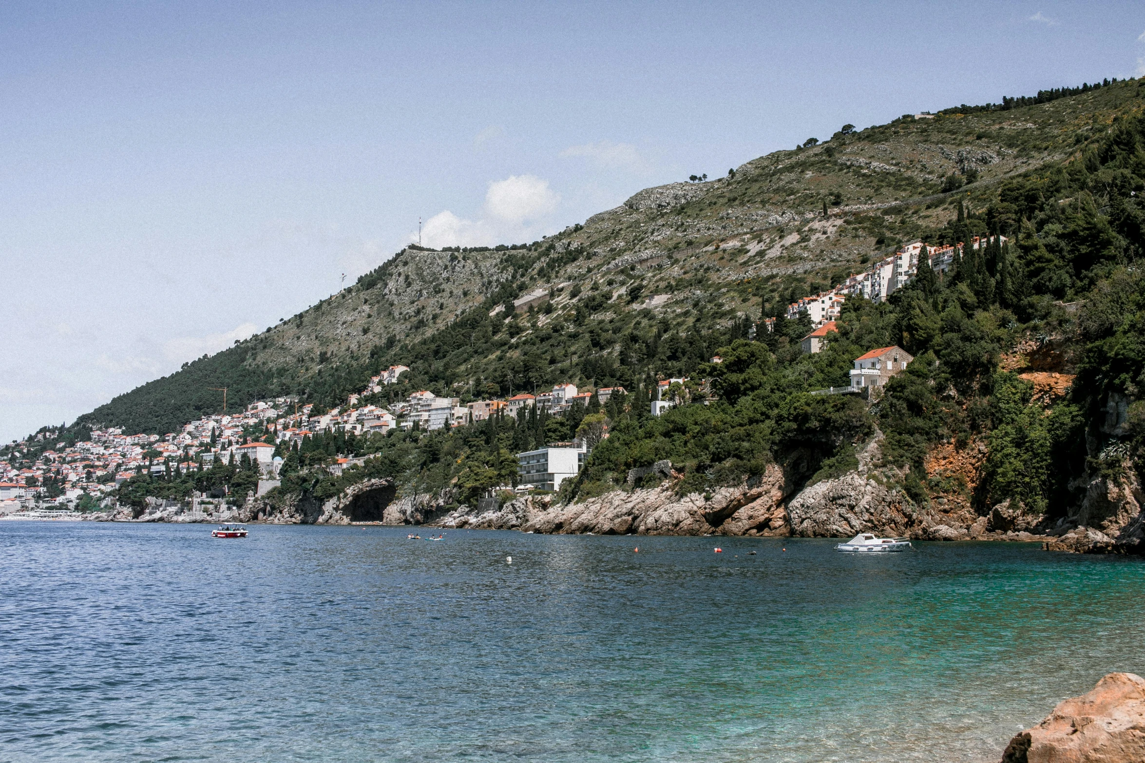 a beach next to the shore in a town