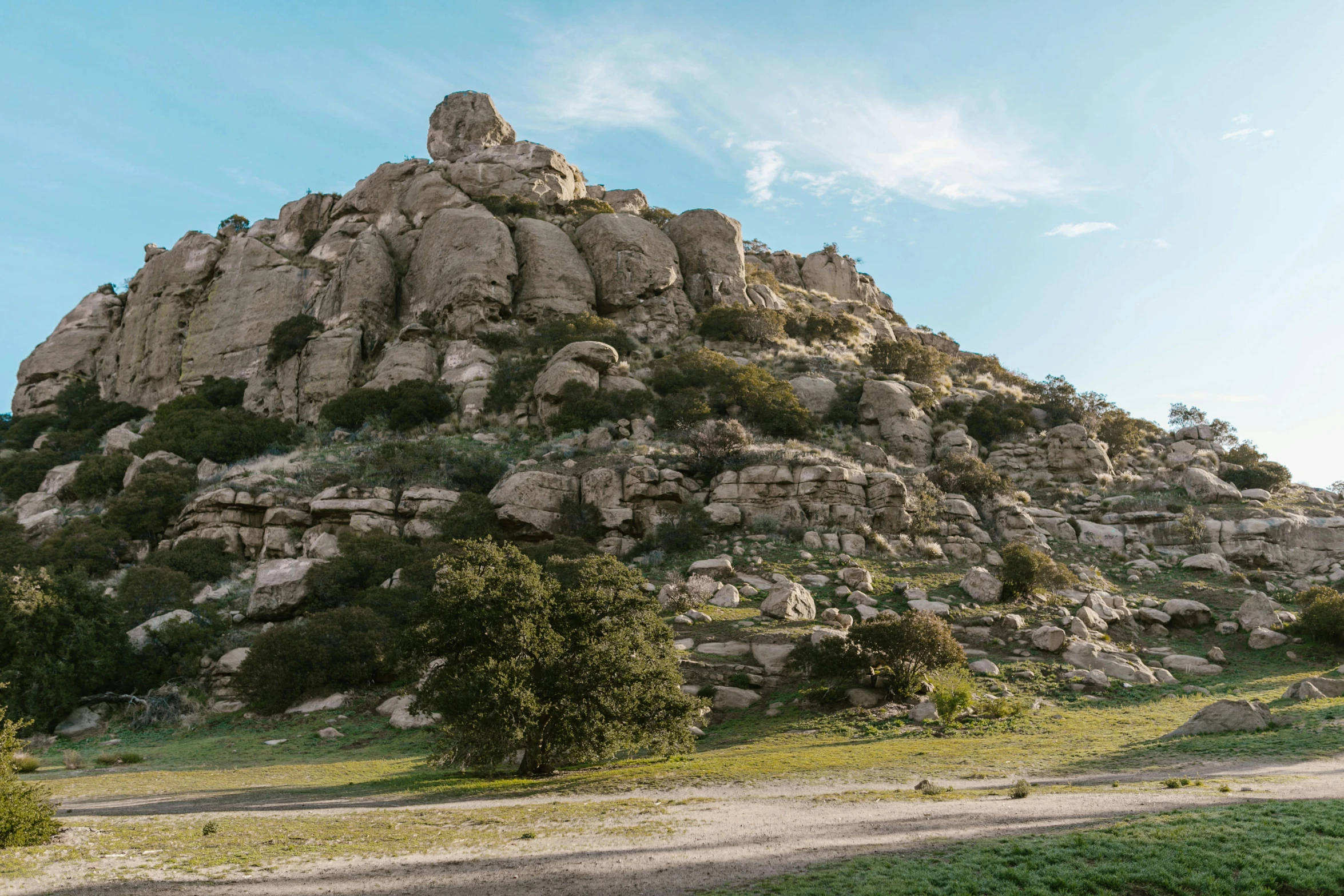 a hillside full of rocks on a clear day
