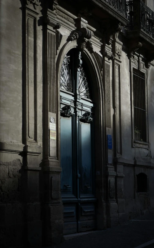 an old building with the door opened to show light