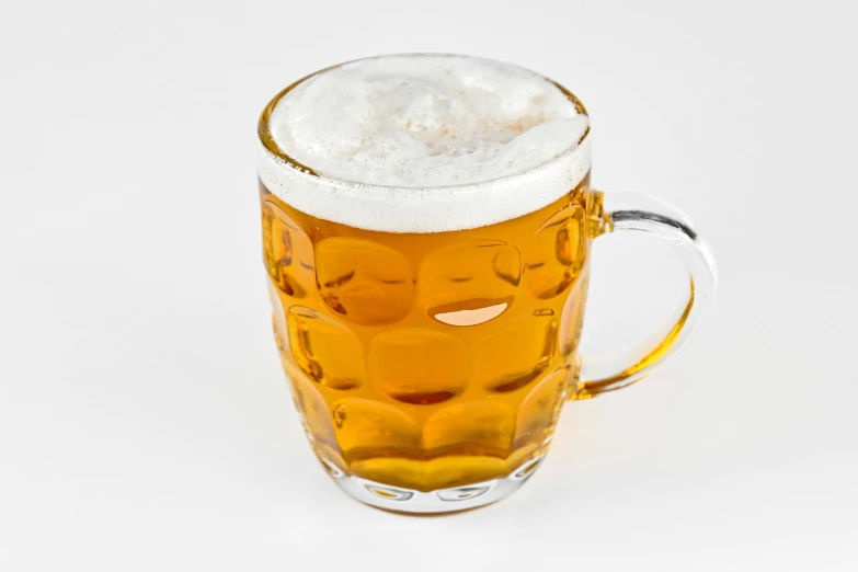 a glass filled with lots of beer with foam