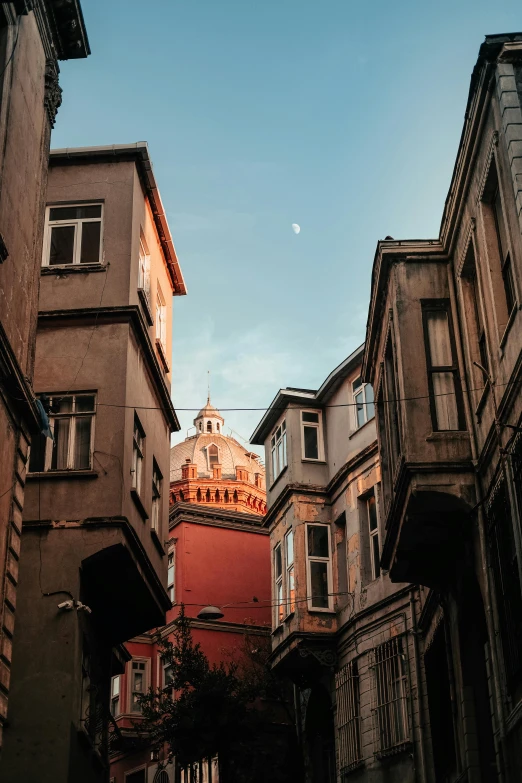 a view of a large building from down the narrow alleyway