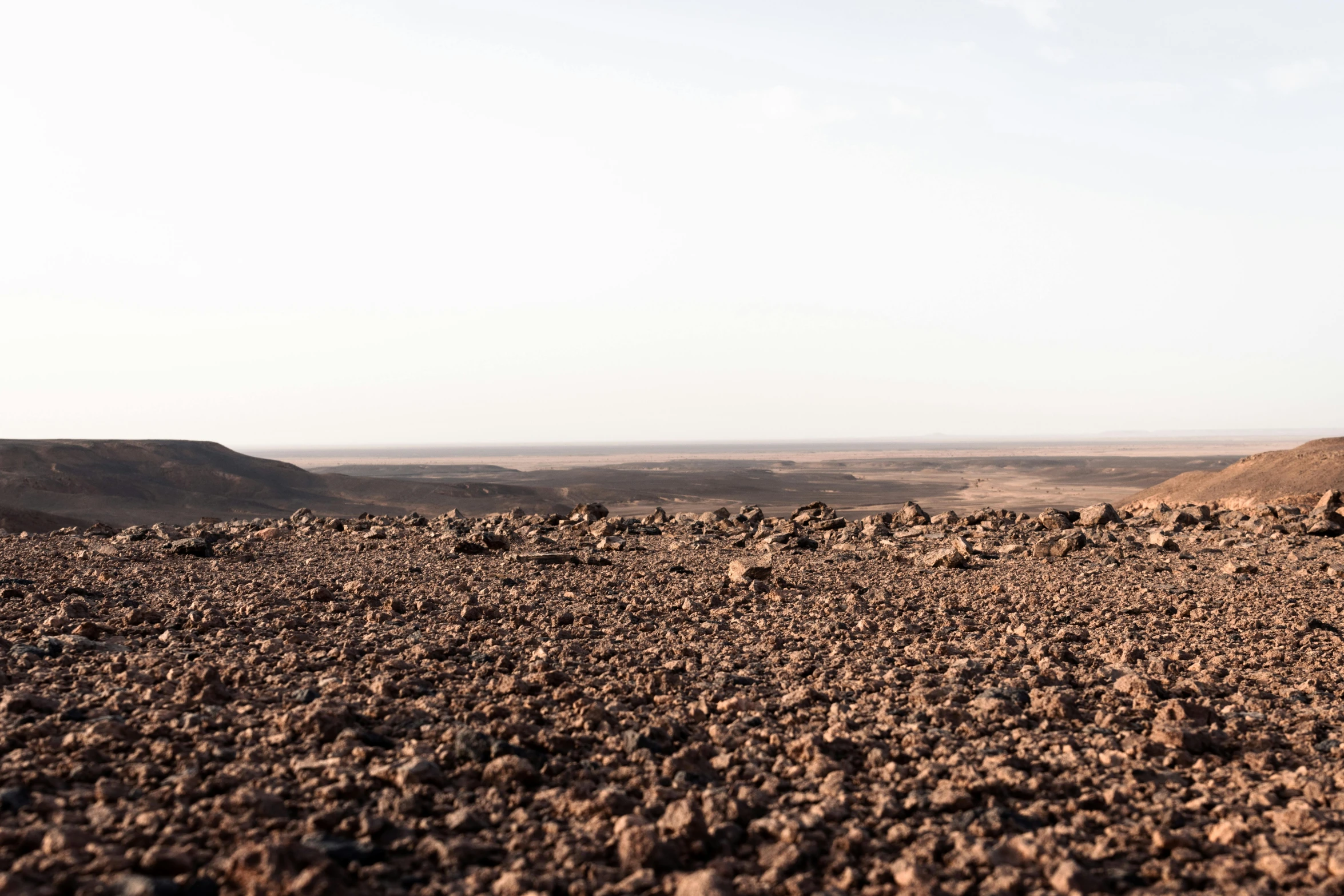 a desert plain with mountains in the distance