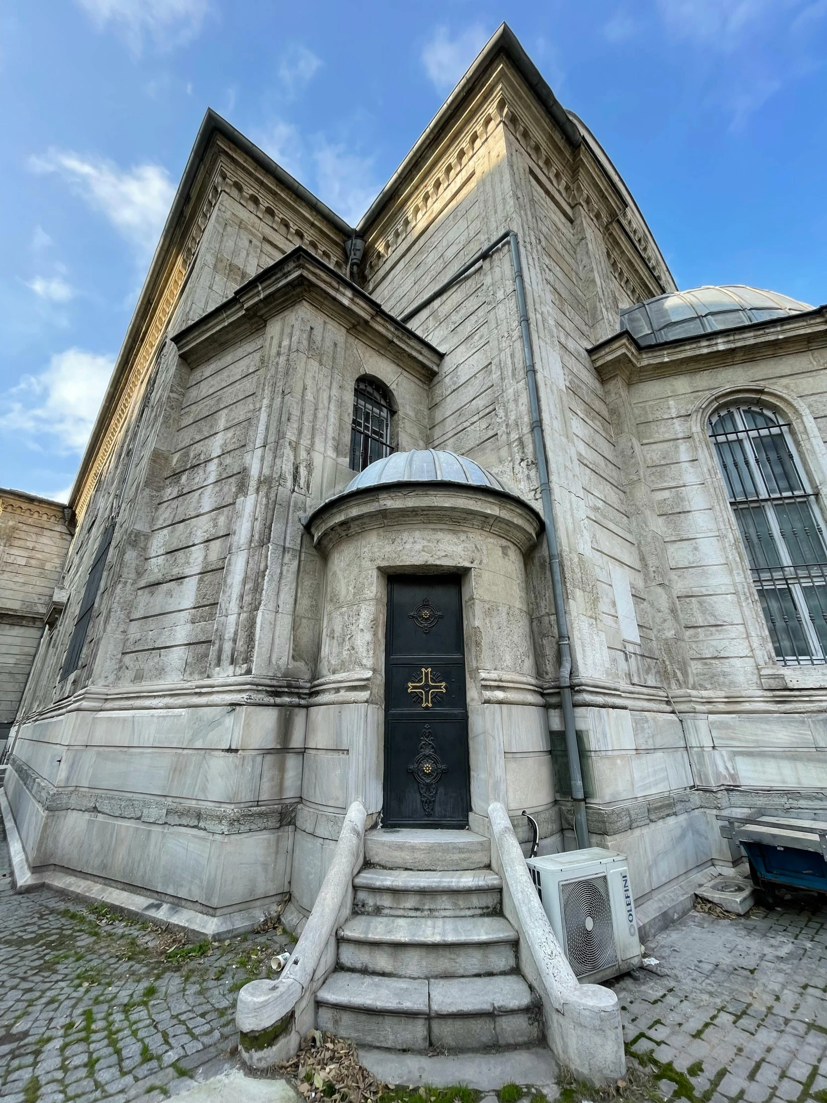 the entrance to an old brick building with steps leading up to it