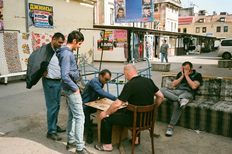 a group of people are outside of a building