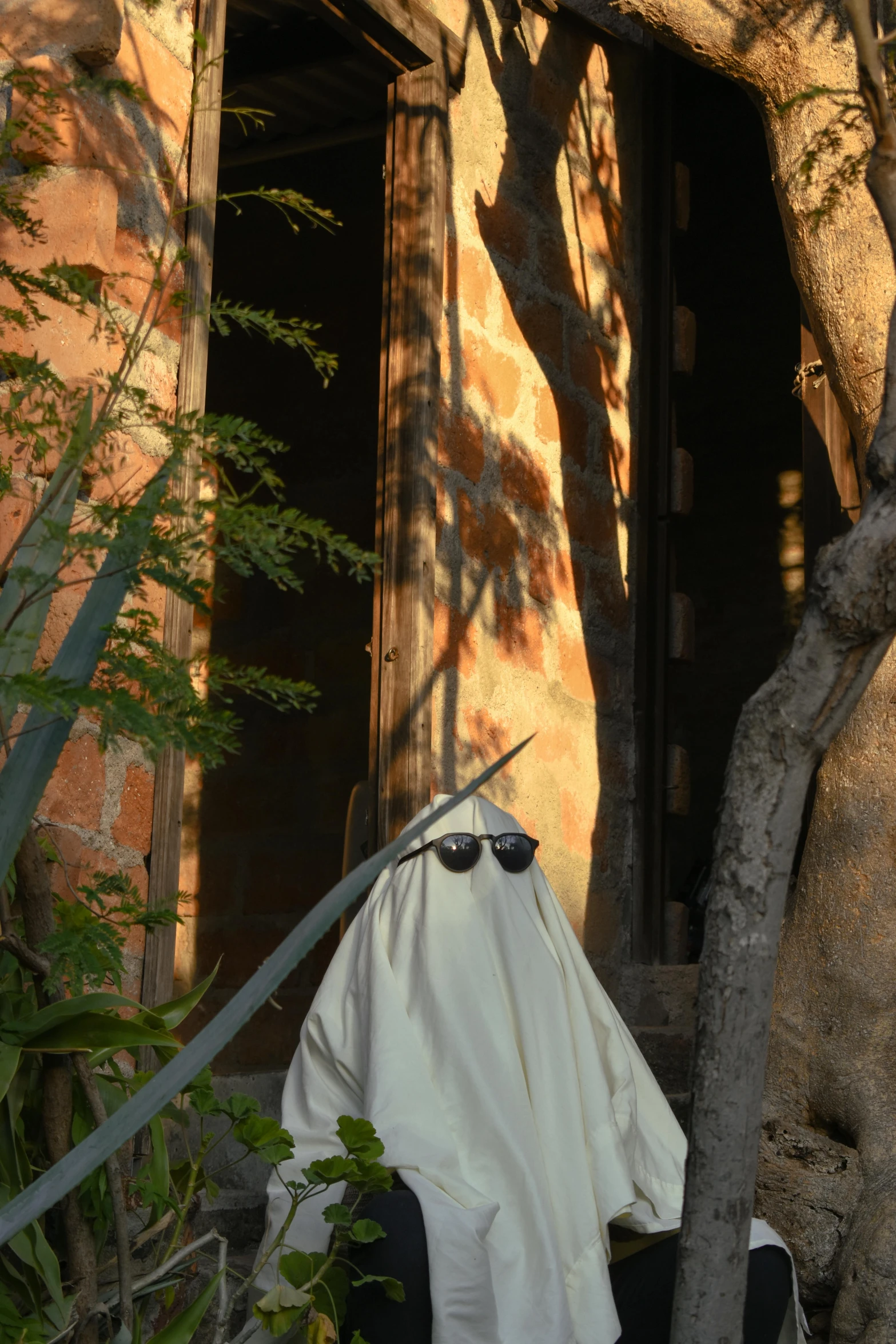 a pair of sunglasses on the clothes that was hung out in front of a building