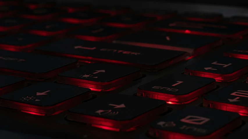 red lights shine on the keys of a keyboard