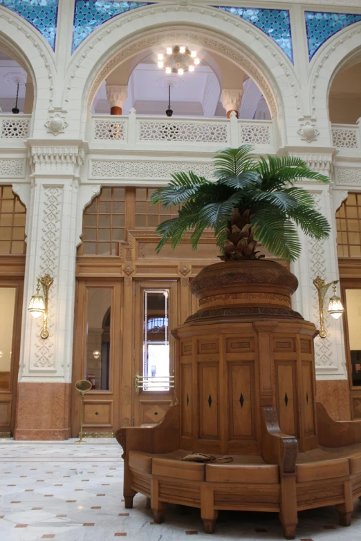 a fancy, wooden bench in an ornate hallway