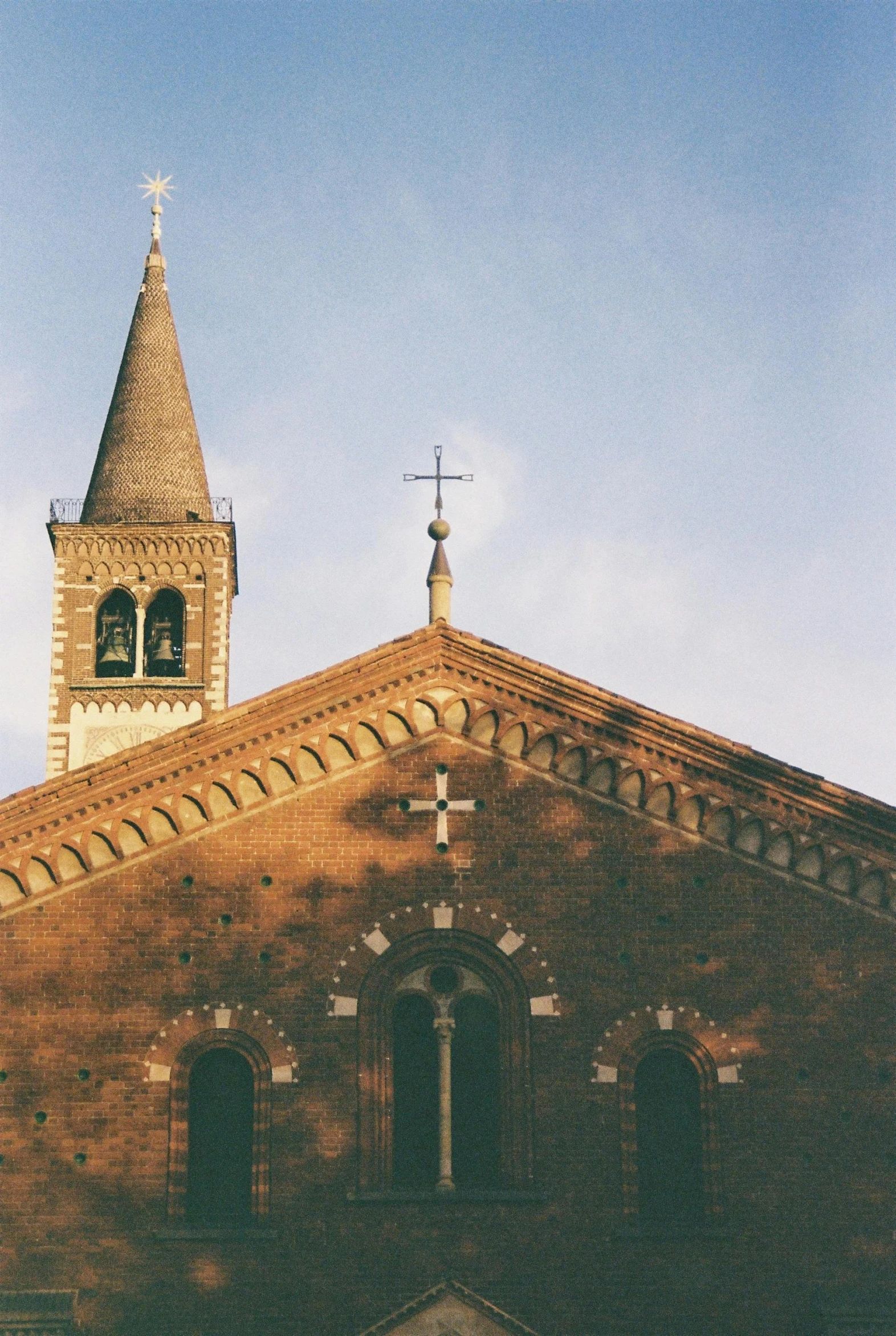 a building with a steeple has a cross on the top